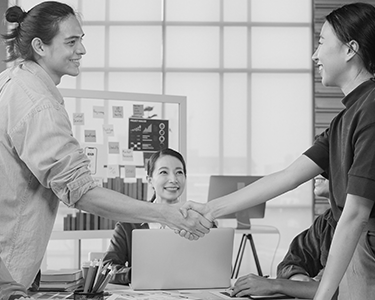 multiracial-group-young-creative-people-smart-casual-wear-discussing-business-shaking-hands-together-smiling-while-standing-modern-office-partner-cooperation-coworker-teamwork-concept